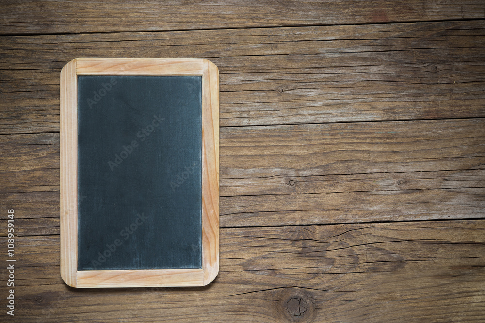 blackboard on antique wooden table with vignette effect blackboard on antique wooden table with vignette effect