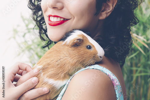 Young woman with Guinea pig on her shoulder
