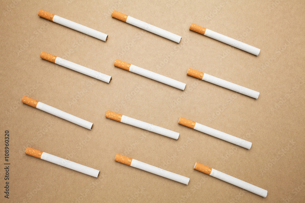 A Cigarettes are flat lay on brown background A Cigarettes are flat lay on brown background