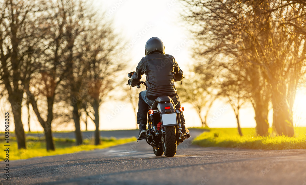 Naklejka premium Young man driving chopper