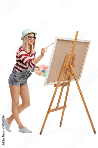 Woman painting on a canvas with paintbrush