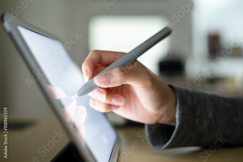 Woman using pen on tablet pc