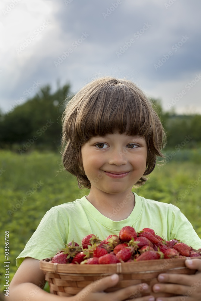 cheerful boy with basket of berries cheerful boy with basket of berries