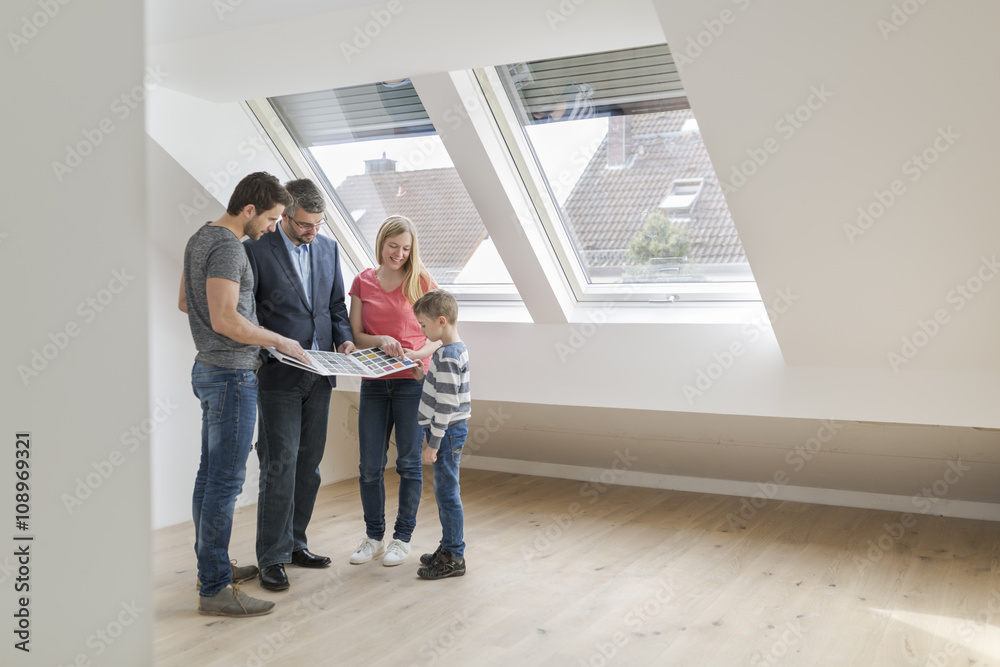 Estate agent showing family sample card in their new penthouse Estate agent showing family sample card in their new penthouse