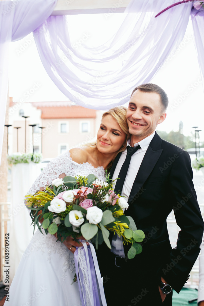 Romantic happy couple, bride & groom posing at wedding aisle Romantic happy couple, bride & groom posing at wedding aisle