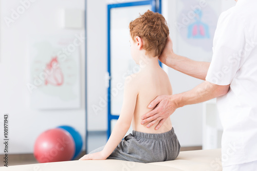 Boy with scoliosis during rehabilitation photo