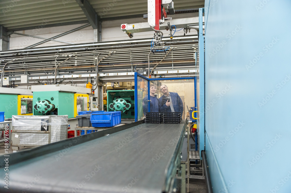 Manager and worker having meeting in plastics factory Manager and worker having meeting in plastics factory