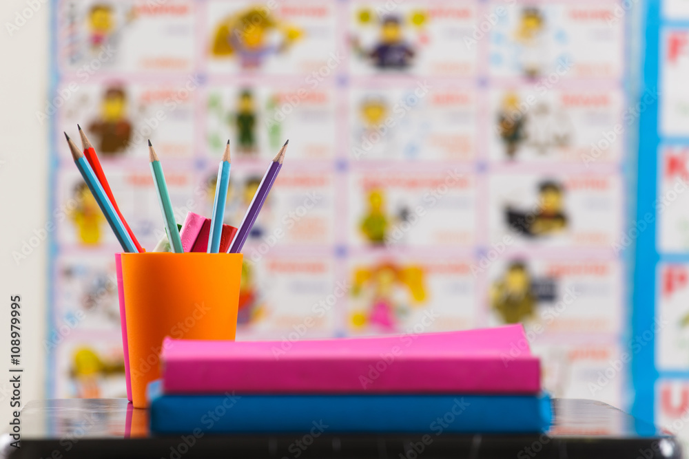 Obraz premium Pencils and book on table