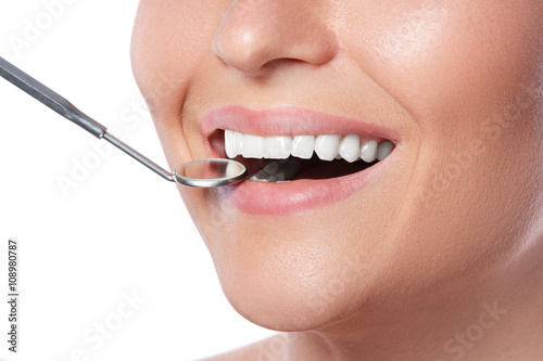 Smiling woman and dental mirror