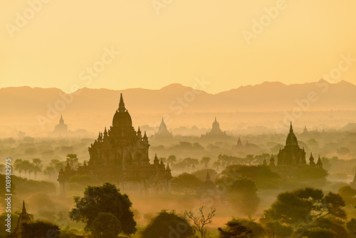 Early morning sunrise at thegroup of ancient pagodas in Bagan pl