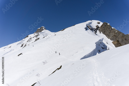 Snowboarders walking uphill for freeride