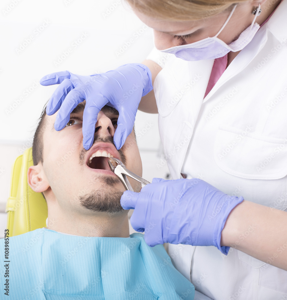 Man having tooth extraction at dental clinic. Dentist, extraction, dental care, teeth. 