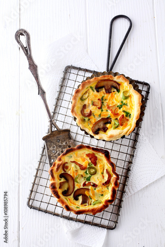 Two tasty seasonal mushroom quiches photo