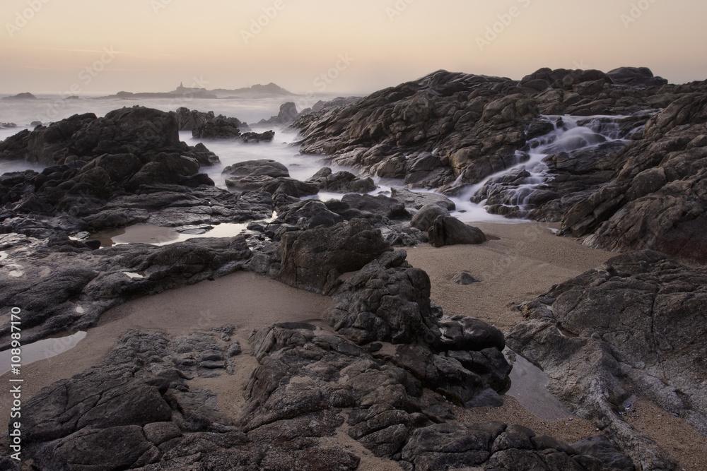 Rocky sea beach at sunset