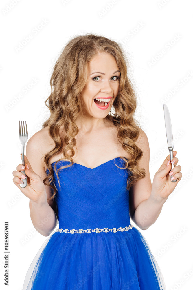 beautiful young girl in elegant blue dress with fork and knife