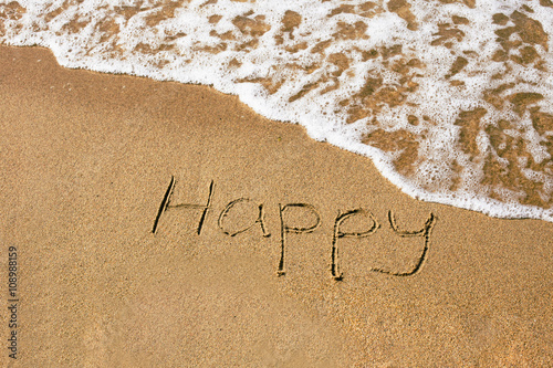 Inscription Happy at the sand on the summer beach