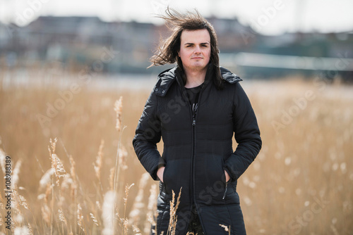 Androgenic man between reed in residential area photo