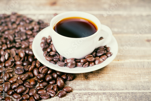 Coffee beans around cup © peshkova