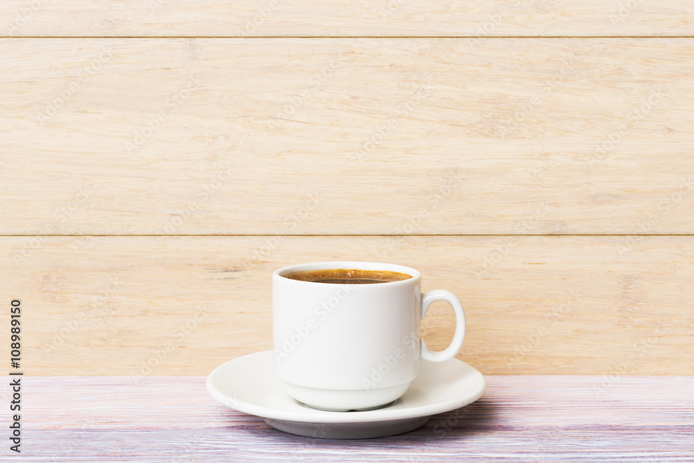 Cup of coffee over light wooden background Cup of coffee over light wooden background