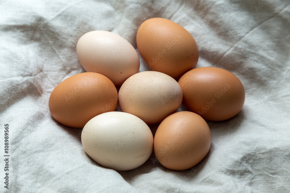 Raw eggs on linen textile Raw eggs on linen textile