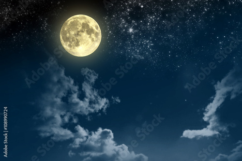 Beautiful magic blue night sky with clouds and fullmoon and stars © volhavasilevich