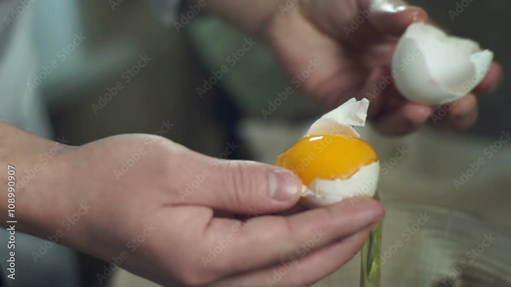 Chef cooking food. Break egg. Closeup. Cooking food. Baking ingredients. Broken eggshell. Preparing food ingredients for baking cake. Chef hands separating yolk from protein Chef cooking food. Break egg. Closeup. Cooking food. Baking ingredients. Broken eggshell. Preparing food ingredients for baking cake. Chef hands separating yolk from protein