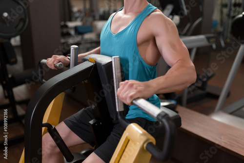 Man working on fitness machine at gym