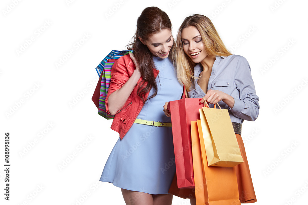 shopping, sale and gifts concept - two smiling teenage girls wit shopping, sale and gifts concept - two smiling teenage girls wit
