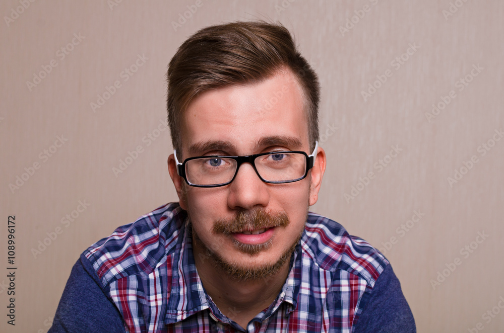 cute guy with a mustache and beard, wearing glasses and a shirt. Happy
