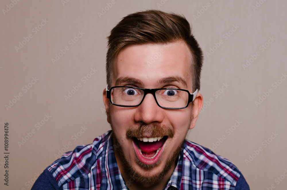 Happy man with open mouth in shirt and glasses. hipster laughing with his mouth wide open. Natural funny emotions. Happy man with open mouth in shirt and glasses. hipster laughing with his mouth wide open. Natural funny emotions.