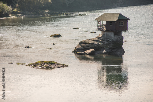 House on rock island in river Drina - Serbia photo