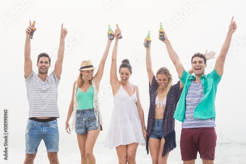 Group of friends holding beer bottle