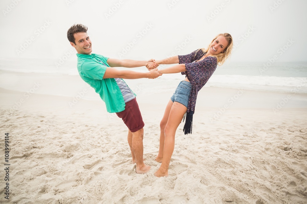 Portrait of happy couple holding hands on the beach Portrait of happy couple holding hands on the beach