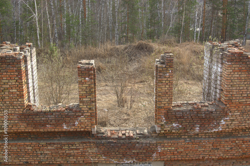 Abandoned unfinished building in a spring forest. Photo is taken in Russian Sibiria. photo