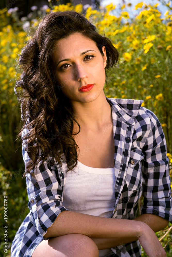 Fototapeta premium gaze of young woman having fun among flowers
