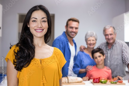 Beautiful young woman standing in kitchen