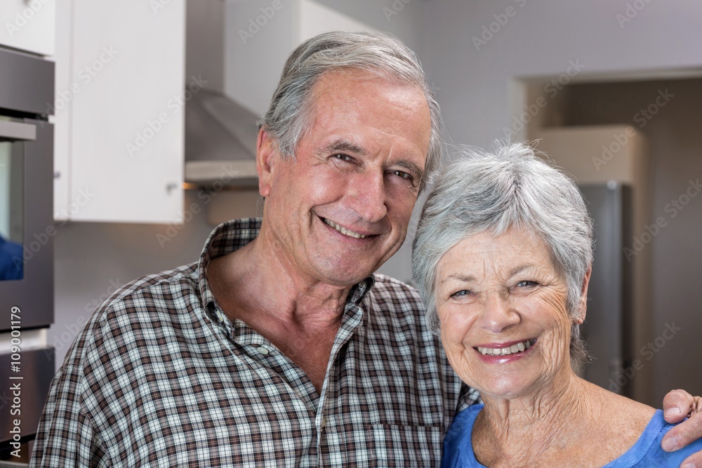 Elderly man and woman standing in kitchen Elderly man and woman standing in kitchen