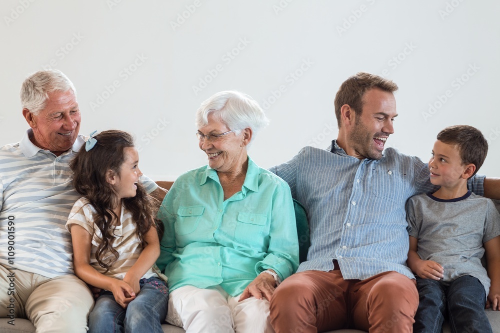 Happy family sitting on sofa