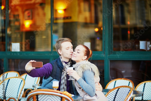 Young romantic couple in cafe in Paris