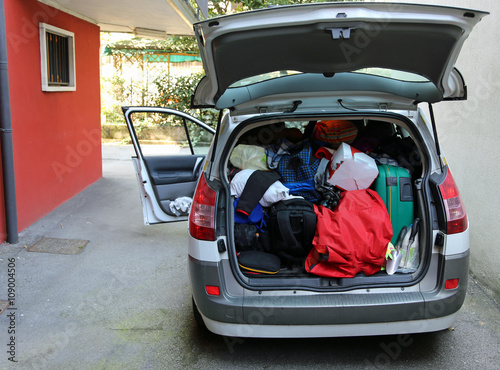 trunk of the car overloaded with bags and luggage