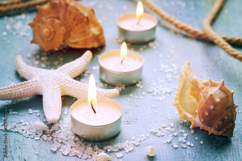 Candles, seashells and starfish on vintage background, tinted