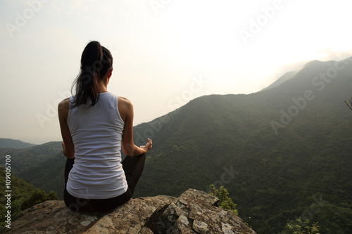 young yoga woman at spring mountain peak