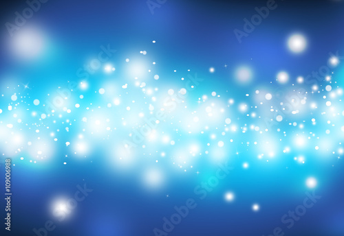 Blue glitter sparkles defocused rays lights bokeh abstract christmas background.