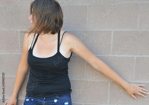 Female beauty expressions against a wall outside. © oscar williams