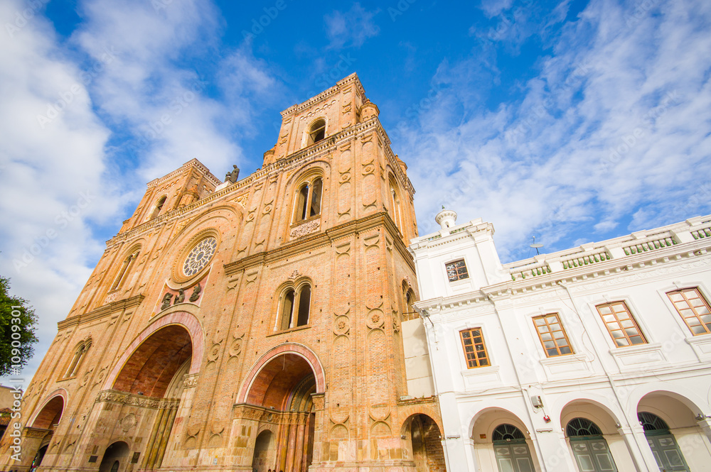 Cuenca, Ecuador - April 22, 2015: Spectacular main cathedral located in the heart of city, beautiful brick architecture and facade as seen from street level