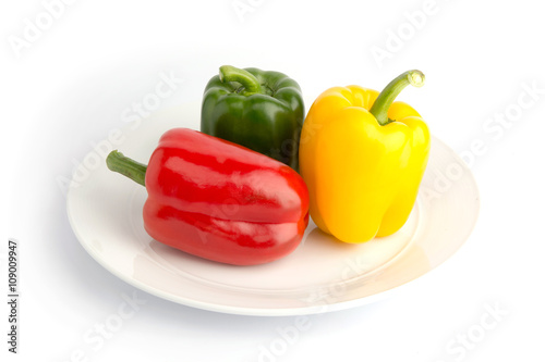 Sweet peppers in ceramic plate on white back ground © eakasit