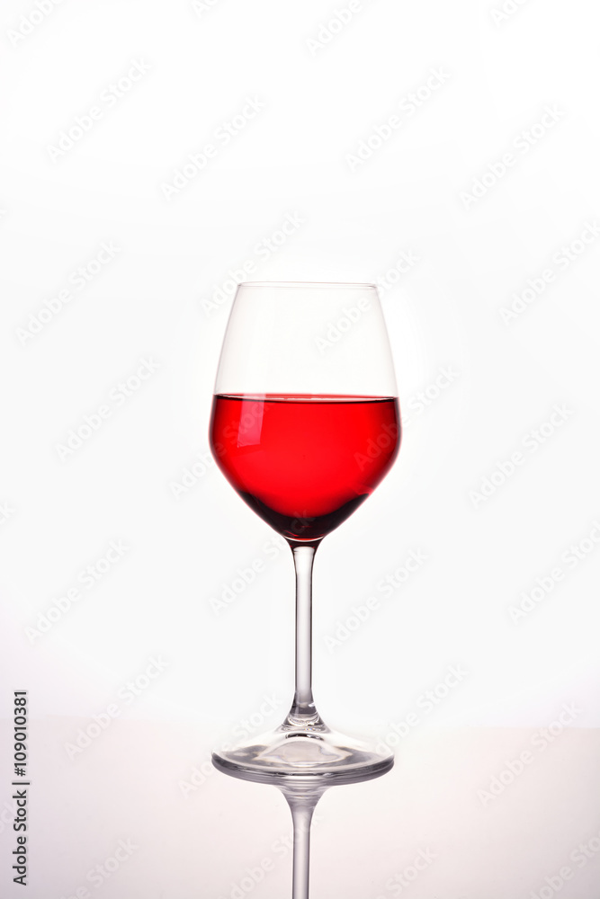 Red water in wine glass on white background Red water in wine glass on white background