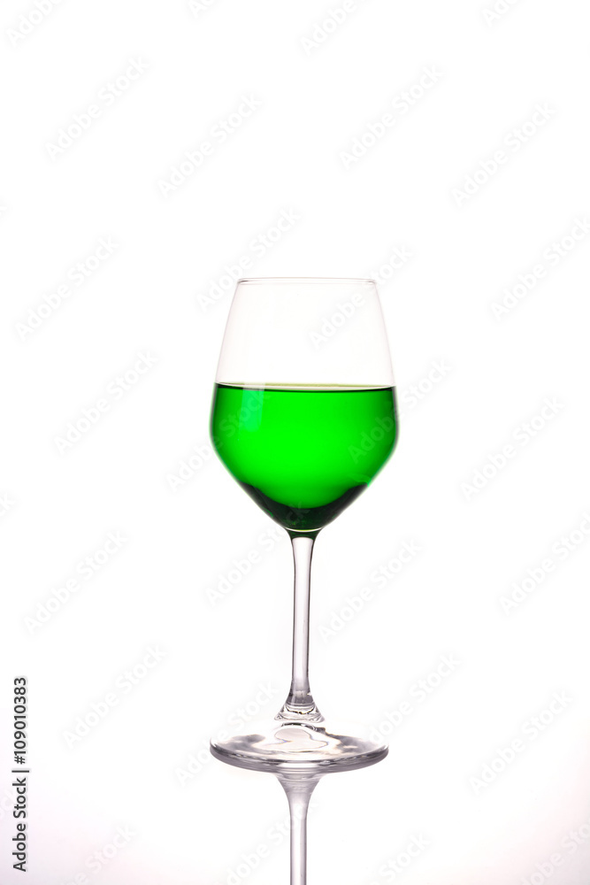 Green water in wine glass on white background Green water in wine glass on white background