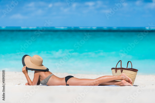Beach summer vacation woman relaxing sunbathing