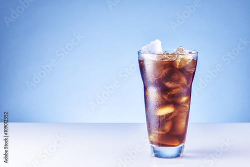 Ice coffee. Blue background with copy space.